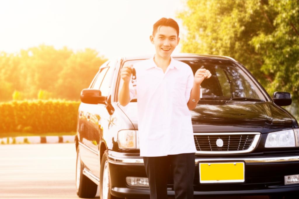 Happy student with newly bought used car in Thailand sun